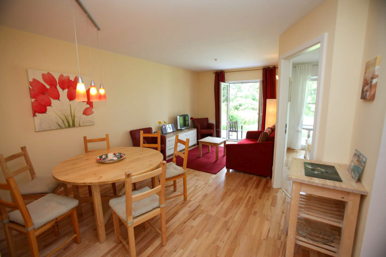 Ferienwohnung Kaiser zum Strande Wohnzimmer mit Sofa und Essecke